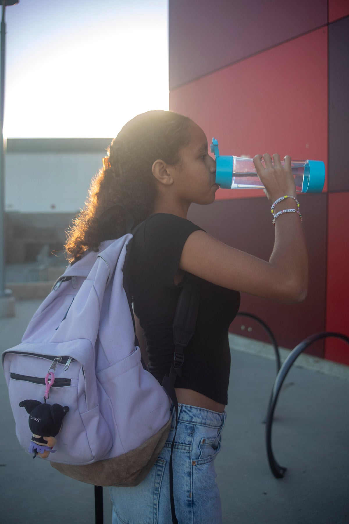 Student drinking from a Whirlbottle water bottle at school