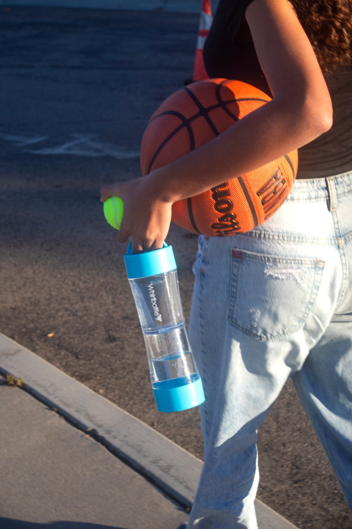 Student carrying a Whirlbottle water bottle during sports