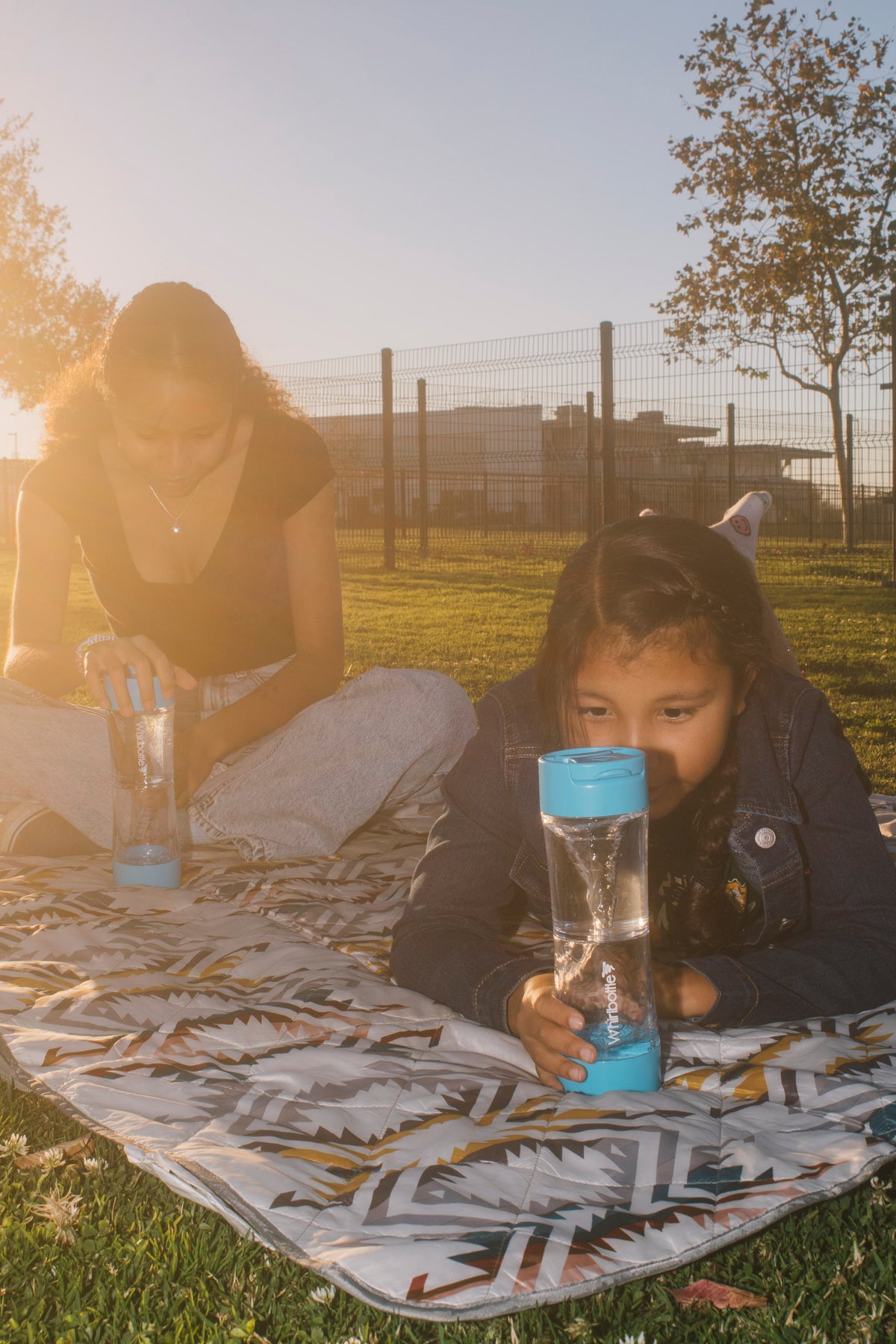 Child using Whirlbottle vortex water bottle outdoors
